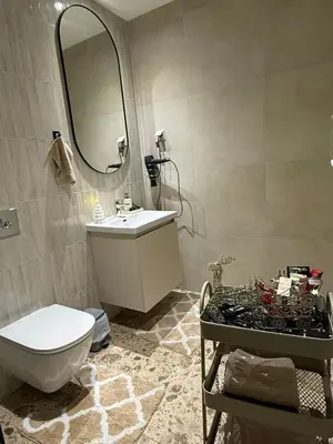 a bathroom with a sink and a toilet and a mirror at Belgrade Waterfront - Beograd na vodi Scala in Belgrade