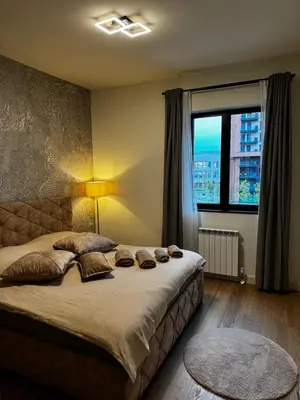 a bedroom with a large bed with a large window at Belgrade Waterfront - Beograd na vodi Scala in Belgrade