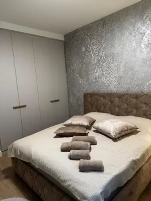 a bed with three pillows on it in a bedroom at Belgrade Waterfront - Beograd na vodi Scala in Belgrade