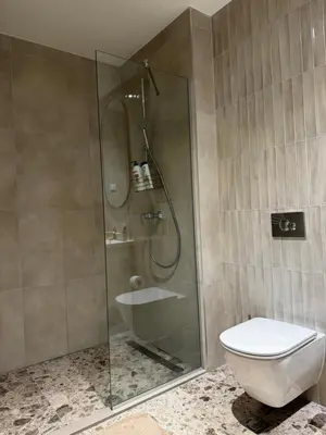 a bathroom with a glass shower with a toilet at Belgrade Waterfront - Beograd na vodi Scala in Belgrade