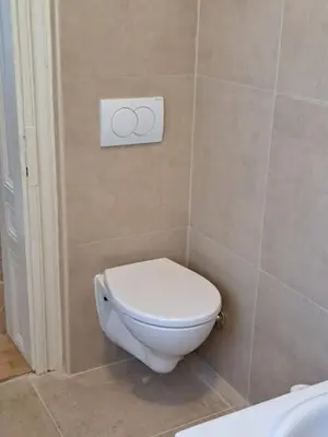 a bathroom with a toilet with a sign on the wall at Eagles Court - Orlovski Vrt in Staji°evo