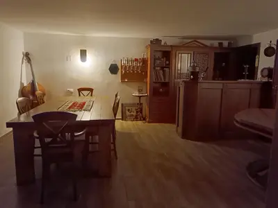a living room with a table and a dining room at Jablanicki Refugium in Pružatovac