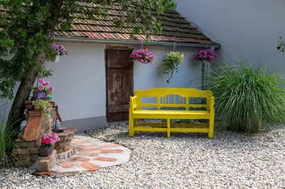 a yellow bench sitting in front of a building at Carska oaza in Lukino Selo