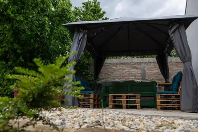 a black tent with chairs and tables under it at Carska oaza in Lukino Selo