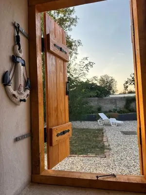 an open door with a view of a yard at Carska oaza in Lukino Selo