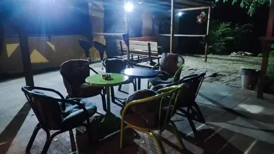 a group of chairs and tables in a patio at night at Kuća za proslave i odmor ZMAJEVO GNEZDO in Pe°ani