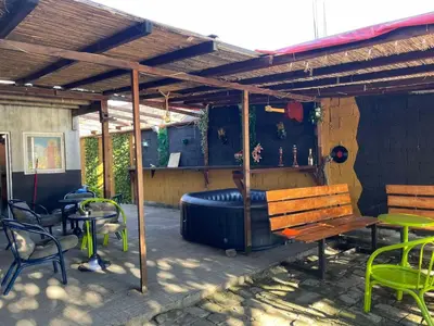 an outdoor patio with a bench and a inflatable at Kuća za proslave i odmor ZMAJEVO GNEZDO in Pe°ani