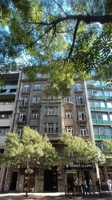 a large building with people standing in front of it at Authentic Belgrade Centre - 4 Suites in One Space, with patios in courtyard for smokers in Belgrade