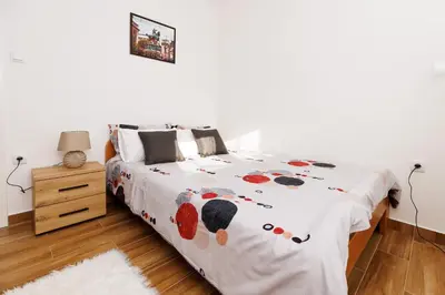 a bedroom with a bed with a bedspread with polka dots at Shiny in Bele Vode