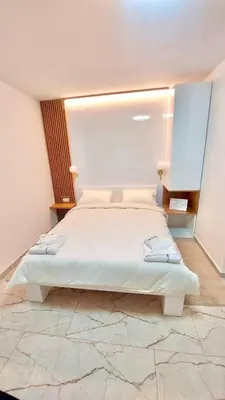 a bedroom with a large bed in a room at AIRPORT APARTMANI HAPPY HOUSE free parking & early check-in in Surčin