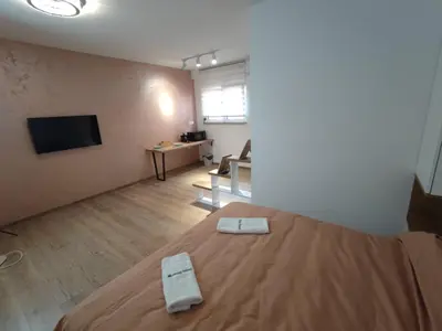 a room with a bed with two white towels on it at AIRPORT APARTMANI HAPPY HOUSE free parking & early check-in in Surčin