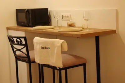 a bar with two glasses and a table with a towel at AIRPORT APARTMANI HAPPY HOUSE free parking & early check-in in Surčin