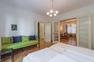 a bedroom with a bed and a green couch at Central Belgrade Apartment 2 in Belgrade