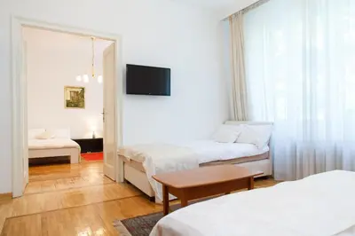 a hotel room with two beds and a tv at Central Belgrade Apartment 2 in Belgrade