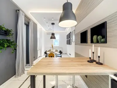 a dining room and living room with a wooden table at Enjoy B-52 Crown in Belgrade
