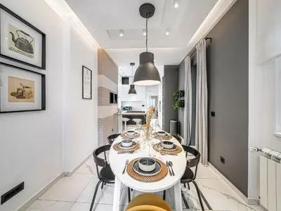 a white dining room with a white table and chairs at Enjoy B-52 Crown in Belgrade