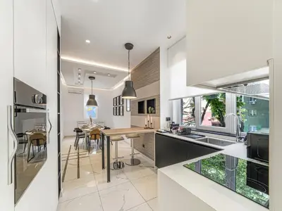 a kitchen with white walls and a wooden counter top at Enjoy B-52 Crown in Belgrade