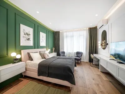 a bedroom with green walls and a bed and a desk at Enjoy B-52 Crown in Belgrade