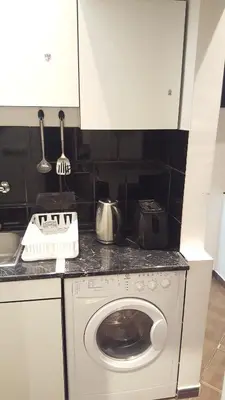 a kitchen with a washing machine in a kitchen at Slavija Square Apartment Cvetni Trg in Belgrade