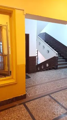 a view of a yellow building with a staircase at Slavija Square Apartment Cvetni Trg in Belgrade
