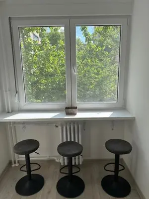 two stools sitting in front of a window at Modern one bedroom in the center of Belgrade in Belgrade
