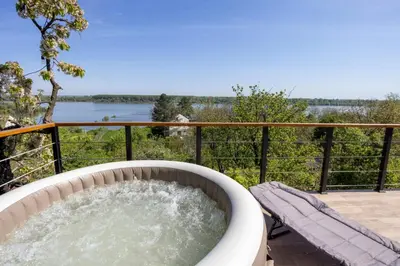 a bath tub with water in it on a deck at Honey Spa house in Novi Slankamen