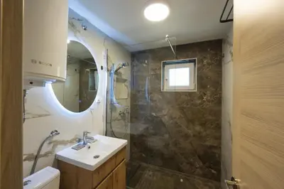 a bathroom with a sink and a shower at Honey Spa house in Novi Slankamen