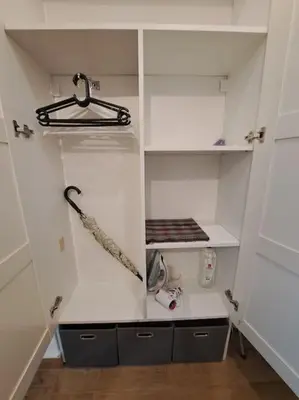a walk in closet with white cabinets and a shelf at Cozy lux bedroom apt with balcony in Dorcol in Belgrade