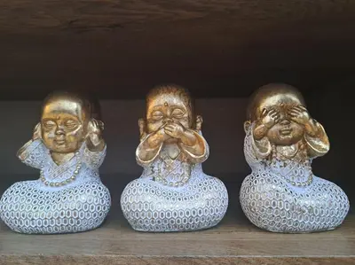 three vases sitting on top of a shelf with their faces at Cozy lux bedroom apt with balcony in Dorcol in Belgrade