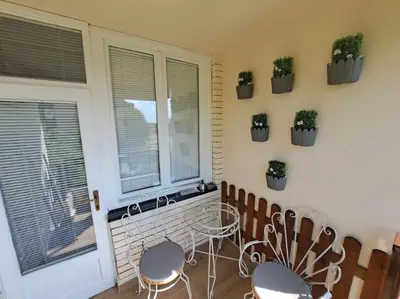 a room with chairs and a table and a window at Cozy lux bedroom apt with balcony in Dorcol in Belgrade