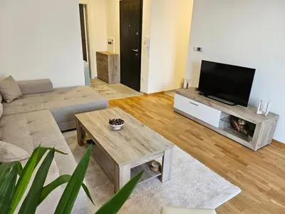 a living room with a couch and a flat screen tv at Aurora lux in Belgrade