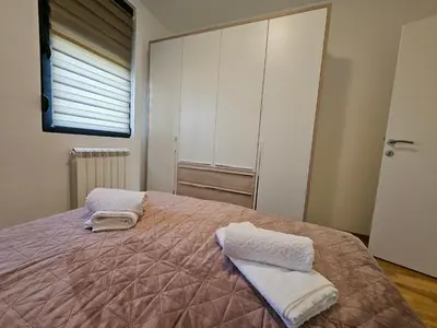 a bedroom with a bed with two towels on it at Aurora lux in Belgrade
