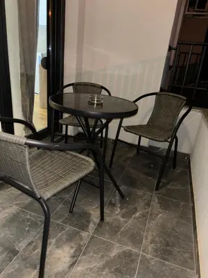 two chairs and a table and two tables and chairs at Aurora lux in Belgrade