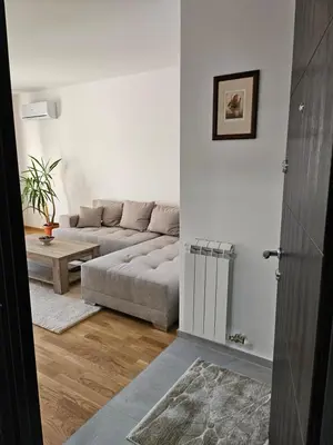 a living room with a couch and a table at Aurora lux in Belgrade