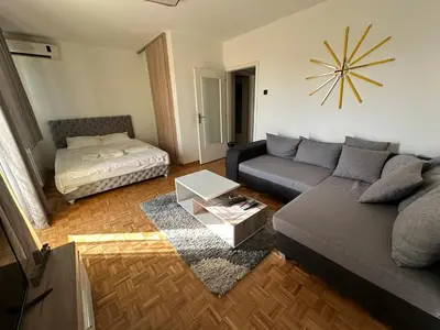 a living room with a couch and a bed at Apartment 601 in Surčin