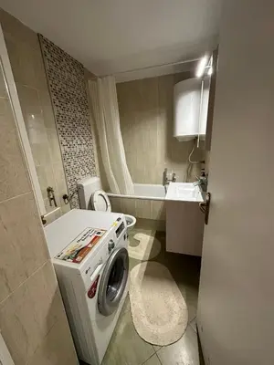 a small bathroom with a washing machine in it at Apartment 601 in Surčin