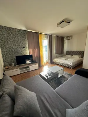 a living room with a couch and a tv at Apartment 601 in Surčin