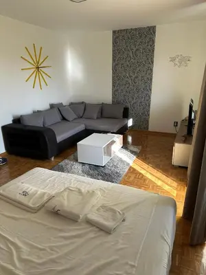 a living room with a couch and a bed at Apartment 601 in Surčin