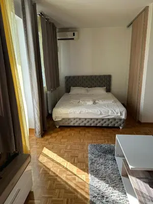 a small bedroom with a bed and a table at Apartment 601 in Surčin