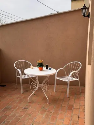 two chairs and a table and a table and two chairs at Blue apartman in Belgrade