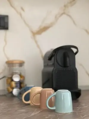a group of coffee cups sitting on a table at Blue apartman in Belgrade