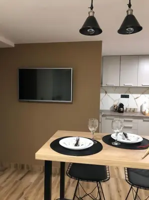 a kitchen with a table with two wine glasses on it at Blue apartman in Belgrade