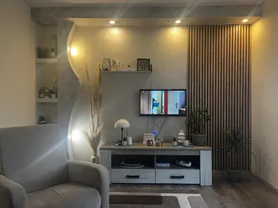 a living room with a couch and a television at Tea i Una in Arandjelovac