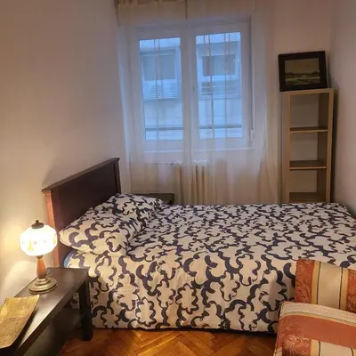 a bedroom with a bed and a window at Soulful Apartment Belgrade in Belgrade