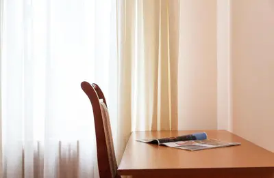 a wooden table with a pen on it next to a window at Central Belgrade Apartments 1 in Belgrade