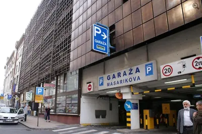 a building with a parking sign on the side of it at Central Belgrade Apartments 1 in Belgrade