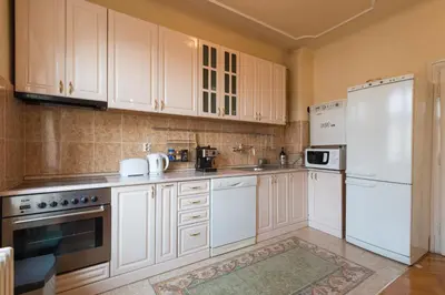 a kitchen with white appliances and white cabinets at Central Belgrade Apartments 1 in Belgrade