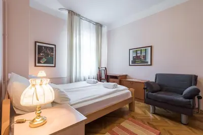 a hospital room with a bed and a chair at Central Belgrade Apartments 1 in Belgrade