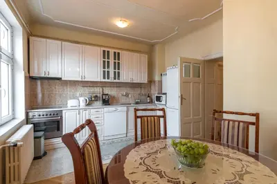 a kitchen with a table with a bowl of fruit on it at Central Belgrade Apartments 1 in Belgrade