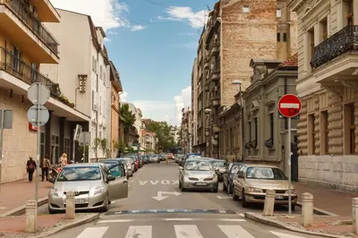 a busy city street with cars parked on the street at Central Belgrade Apartments 3 in Belgrade